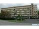 Condominium building featuring multiple stories and well-maintained landscaping at 3620 Ironwood Cir # 506-O, Bradenton, FL 34209