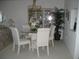 Inviting dining area featuring a glass table with upholstered chairs and decorative accents at 3620 Ironwood Cir # 506-O, Bradenton, FL 34209
