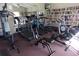 Community gym featuring treadmills, exercise bikes, and a mirrored wall with book shelves at 3620 Ironwood Cir # 506-O, Bradenton, FL 34209