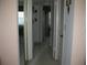 Hallway with mirror, doors, and neutral colors, providing access to various rooms at 3620 Ironwood Cir # 506-O, Bradenton, FL 34209