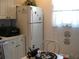 Compact kitchen featuring essential appliances and cozy dining area with natural light at 3620 Ironwood Cir # 506-O, Bradenton, FL 34209