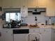 Functional kitchen with white cabinets and essential appliances for culinary needs at 3620 Ironwood Cir # 506-O, Bradenton, FL 34209