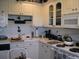Bright kitchen with white cabinets, modern appliances, and efficient countertop space at 3620 Ironwood Cir # 506-O, Bradenton, FL 34209