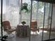 Bright lanai featuring comfortable seating, a table, and views of the surrounding greenery at 3620 Ironwood Cir # 506-O, Bradenton, FL 34209