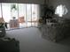 Open living room leading to a screened-in patio, creating a seamless indoor-outdoor experience at 3620 Ironwood Cir # 506-O, Bradenton, FL 34209