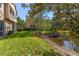 A view of backyard featuring a pond, lush lawn and screen enclosed patios at 3671 Parkridge Cir # 8-201, Sarasota, FL 34243