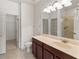 Bright bathroom featuring a dark vanity, a large mirror, and a separate shower area at 3671 Parkridge Cir # 8-201, Sarasota, FL 34243
