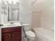 Bathroom with a vanity with dark wood cabinets and tile surround bathtub at 3671 Parkridge Cir # 8-201, Sarasota, FL 34243