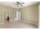 Bedroom with neutral tones, carpeted floor, and multiple doorways at 3671 Parkridge Cir # 8-201, Sarasota, FL 34243