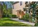Charming two-story tan home with a well-manicured lawn, lush landscaping, and a welcoming covered entryway at 3671 Parkridge Cir # 8-201, Sarasota, FL 34243