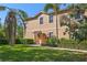 Inviting townhome exterior with lush landscaping, a private entrance, and a charming covered porch in a warm color scheme at 3671 Parkridge Cir # 8-201, Sarasota, FL 34243