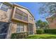 Exterior townhome view featuring a screen enclosed patio and balcony overlooking the manicured landscaping at 3671 Parkridge Cir # 8-201, Sarasota, FL 34243