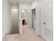 Hallway with carpet leads to a bathroom and laundry area at 3671 Parkridge Cir # 8-201, Sarasota, FL 34243