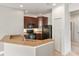 Cozy kitchen featuring black appliances, wood cabinetry, and stone countertops at 3671 Parkridge Cir # 8-201, Sarasota, FL 34243