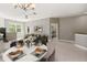 Open-concept living area with dining space, plush seating, and an inviting view of the adjacent bedroom at 3671 Parkridge Cir # 8-201, Sarasota, FL 34243