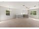 Spacious and bright loft area with carpet flooring, neutral paint, windows and ceiling fan at 3671 Parkridge Cir # 8-201, Sarasota, FL 34243