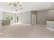 Bright loft with neutral walls, carpeting, windows, balcony and elegant light fixture at 3671 Parkridge Cir # 8-201, Sarasota, FL 34243
