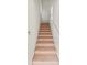 Carpeted staircase with white trim leads to the upper level with lots of light and bright space at 3671 Parkridge Cir # 8-201, Sarasota, FL 34243