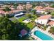 Aerial view of a community featuring a pool, clubhouse, and lush landscaping at 3690 Pinecrest St # 124, Sarasota, FL 34232