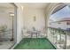 Relaxing balcony space with seating, table setting, and views of the community courtyard at 3690 Pinecrest St # 124, Sarasota, FL 34232