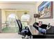 View of balcony with table and chair and garden space with lush landscaping at 3690 Pinecrest St # 124, Sarasota, FL 34232