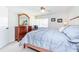 Bright bedroom with a comfortable bed, wooden dresser, and sunny window at 3690 Pinecrest St # 124, Sarasota, FL 34232
