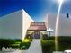 Inviting clubhouse exterior featuring manicured landscaping and a welcoming entrance at 3690 Pinecrest St # 124, Sarasota, FL 34232
