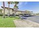 Condo exterior with well-maintained landscaping, covered parking, and mature palm trees on a sunny day at 3690 Pinecrest St # 124, Sarasota, FL 34232