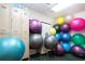 A gym with lockers and exercise balls of varying sizes and colors arranged against the wall at 3690 Pinecrest St # 124, Sarasota, FL 34232