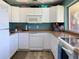 A compact kitchen with white appliances and countertops, designed for functionality at 3690 Pinecrest St # 124, Sarasota, FL 34232