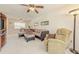 Bright and airy living room with a ceiling fan, plush seating, and carpet flooring at 3690 Pinecrest St # 124, Sarasota, FL 34232