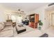 Cozy living room with ceiling fan and sliding door with access to an outdoor balcony at 3690 Pinecrest St # 124, Sarasota, FL 34232