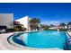 Community pool with sun loungers and landscaped surroundings next to clubhouse at 3690 Pinecrest St # 124, Sarasota, FL 34232