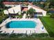 Aerial view of sparkling community pool surrounded by lounge chairs and lush landscaping at 3690 Pinecrest St # 124, Sarasota, FL 34232