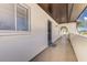 Home entry featuring a concrete porch with a secure screen door, complementing the bright white walls at 3690 Pinecrest St # 124, Sarasota, FL 34232