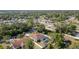 Beautiful aerial view of a home with a screened pool, mature trees, and a fenced backyard in a quiet neighborhood at 3736 Fontainebleau St, North Port, FL 34287