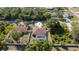 Drone view of a quaint home with a private pool, surrounded by trees and a white picket fence at 3736 Fontainebleau St, North Port, FL 34287