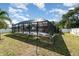 Spacious yard with a large screened patio area and lush lawn at 3736 Fontainebleau St, North Port, FL 34287