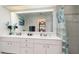 Bathroom with double vanity, large mirror, and tiled shower at 3736 Fontainebleau St, North Port, FL 34287