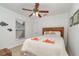 Cozy bedroom featuring a woven headboard, ceiling fan, and bright decor at 3736 Fontainebleau St, North Port, FL 34287