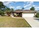 Well-maintained front yard with lush landscaping complements this charming single-story home at 3736 Fontainebleau St, North Port, FL 34287