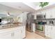 Eat-in kitchen featuring stainless steel appliances, granite countertops, and white cabinetry at 3736 Fontainebleau St, North Port, FL 34287