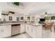 Spacious kitchen featuring granite countertops, white cabinets, and stainless steel dishwasher at 3736 Fontainebleau St, North Port, FL 34287