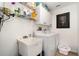 Functional laundry room with washer, dryer, sink, and ample storage shelving at 3736 Fontainebleau St, North Port, FL 34287