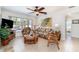 Living room with wicker furniture and tropical decor, and a ceiling fan at 3736 Fontainebleau St, North Port, FL 34287
