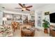 Open floor plan connecting living room, kitchen, and outdoor spaces, with wicker furniture at 3736 Fontainebleau St, North Port, FL 34287