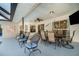 Outdoor patio with comfortable seating and fan overlooks the backyard at 3736 Fontainebleau St, North Port, FL 34287