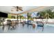 Screened patio featuring ceiling fan and several seating areas near pool at 3736 Fontainebleau St, North Port, FL 34287