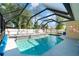 Backyard pool features a screened enclosure and lounge chairs at 3736 Fontainebleau St, North Port, FL 34287