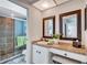 Bright bathroom with updated vanity, decorative mirrors, and walk-in shower at 3978 Lemonwood Dr, Sarasota, FL 34232